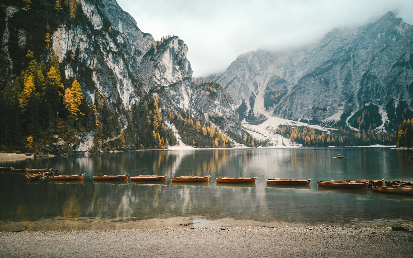 An autumn lake and wooden boats edited with Phos film and tone controls